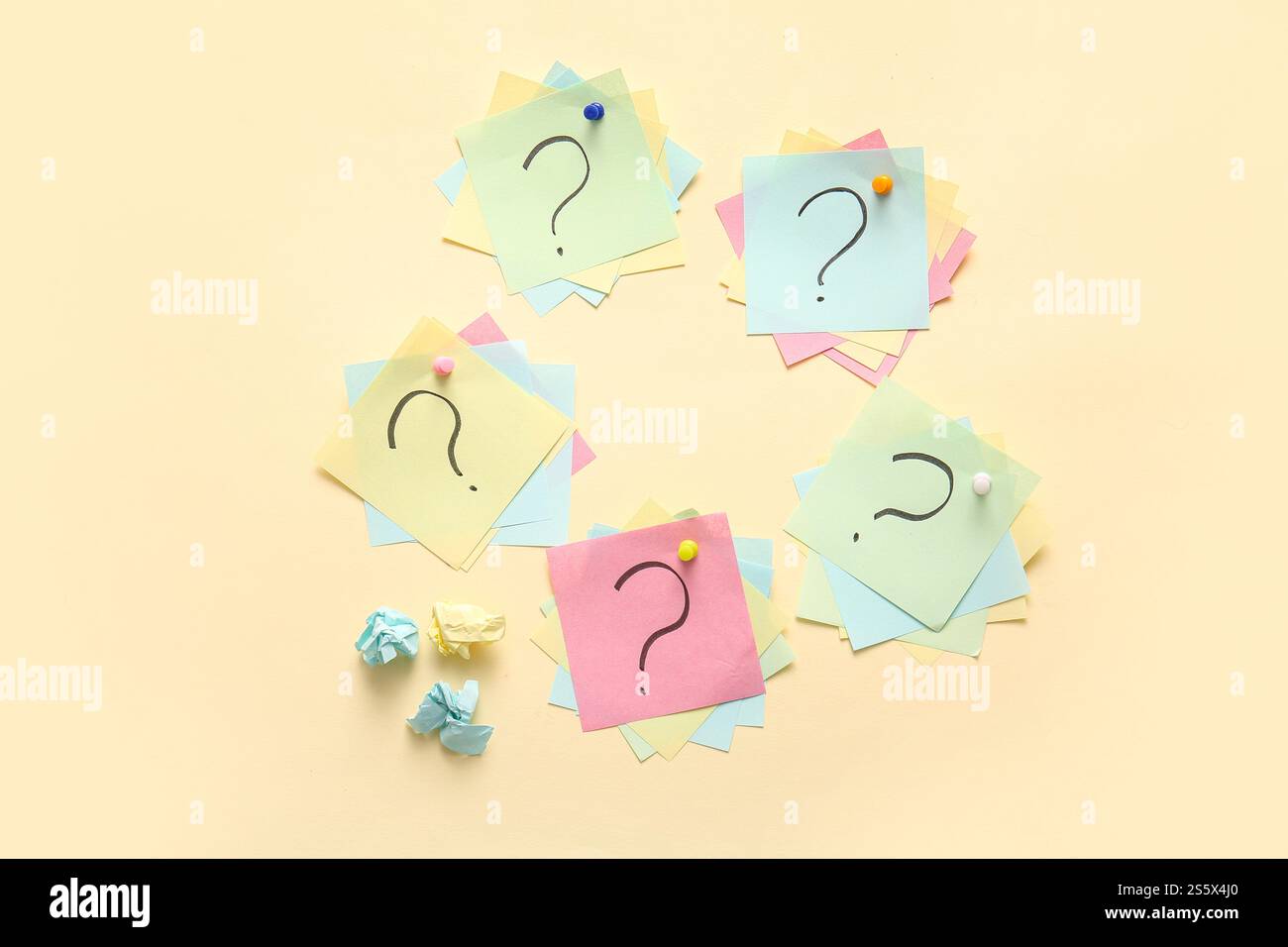 Different sticky notes with question marks pinned on color background Stock Photo
