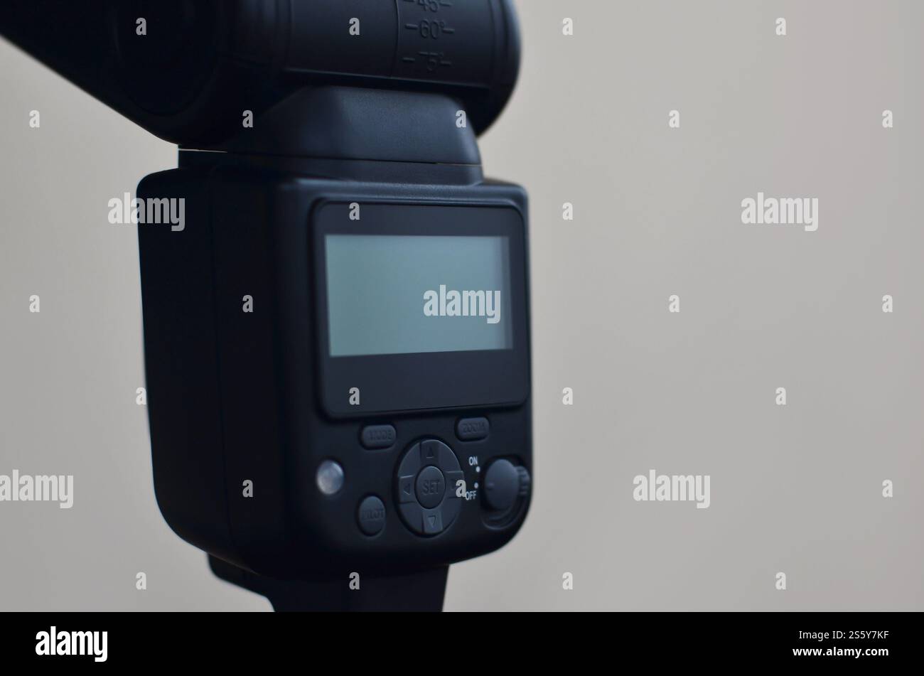 External photographic speedlight gun is mounted on the multichannel sync trigger set on a tripod. lighting equipment for studio photography. Set of Stock Photo