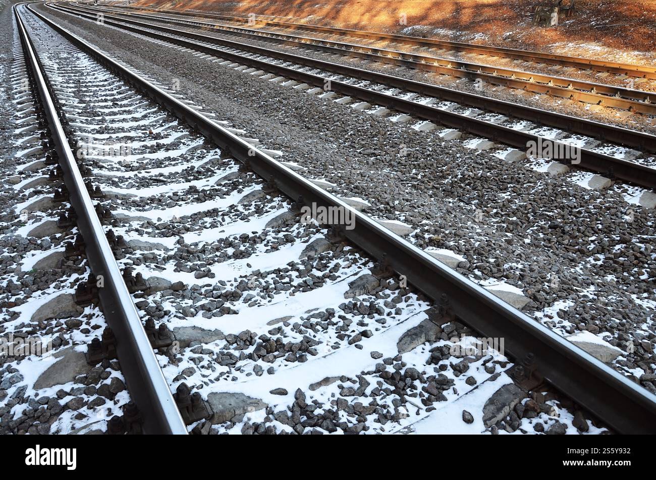 Details snowy Russian winter railway under bright sunlight. The rails and sleepers under the December snow. Russian Railways in detail Stock Photo