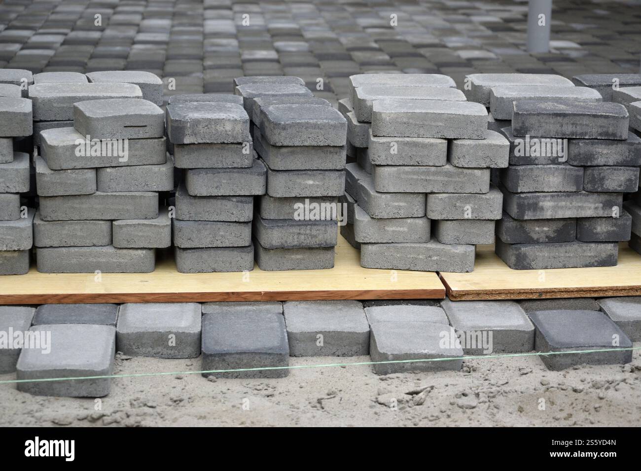 Rows of gray and dark grey walkway slab lying outdoors. Material for ...