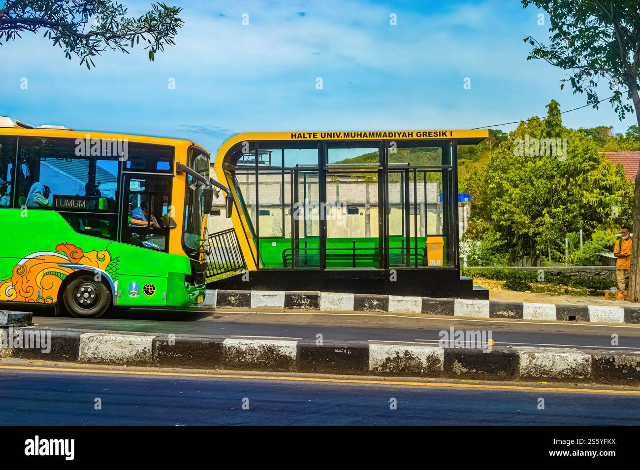 A green Trans Jatim Bus that stops at bus stops. Isuzu small town bus in Indonesia, 27 June, 2023. Stock Photo