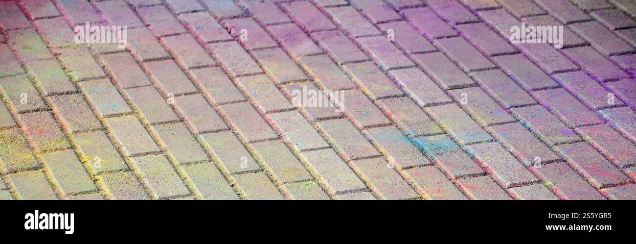 Multi colored earth, paving slabs, powder coated with dry colors at the Holi festival close up. Multi colored paving slabs, powder coated with dry Stock Photo