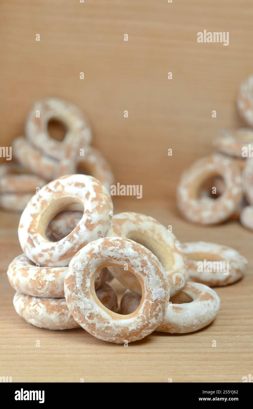 Still life of donut glaze on a wooden surface. Glazed bagels are a small bunch on a wooden table. Flour sweets to the Tea Party Stock Photo