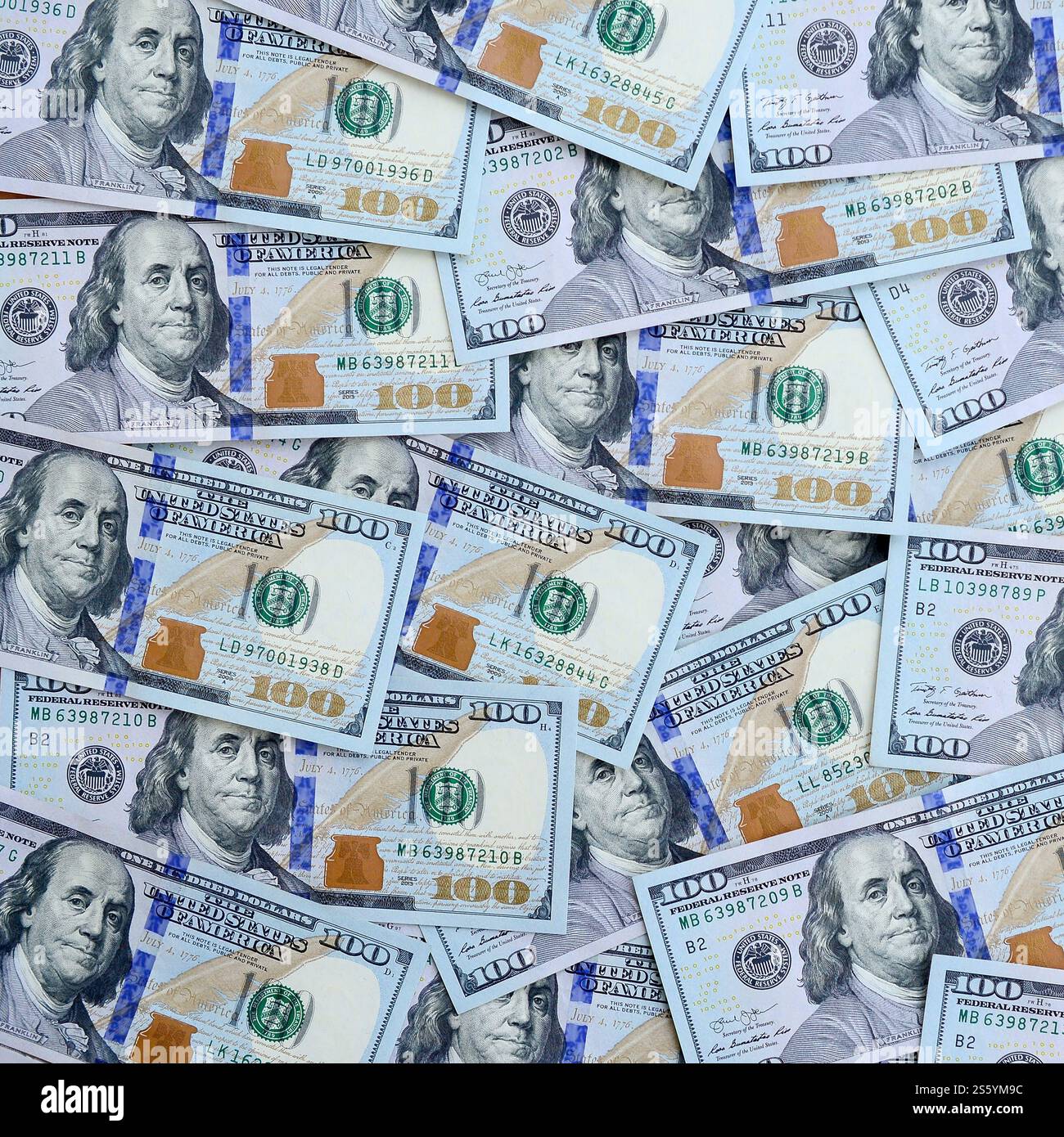 A large number of US dollar bills of a new design with a blue stripe in the middle. Top view. A large number of US dollar bills of a new design with Stock Photo