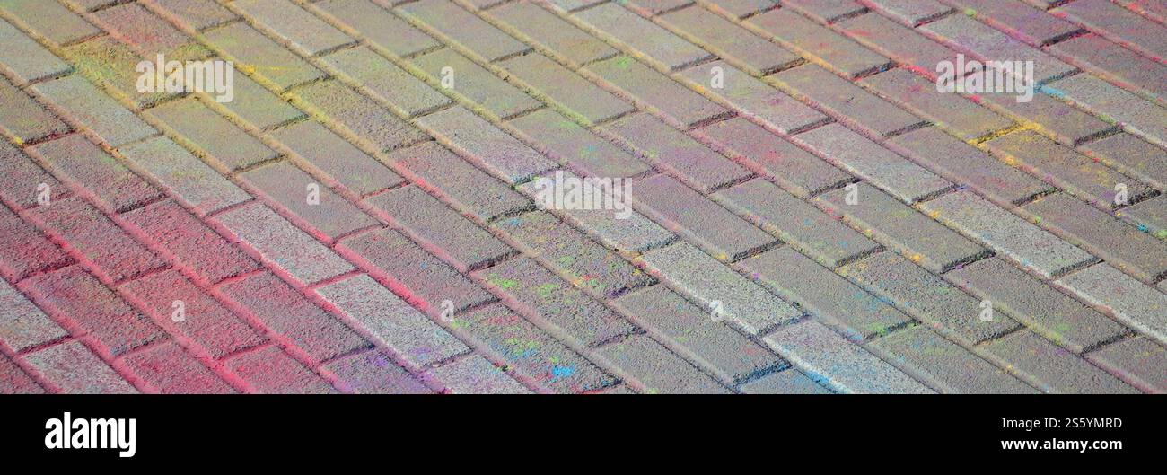 Multi colored earth, paving slabs, powder coated with dry colors at the Holi festival close up. Multi colored paving slabs, powder coated with dry Stock Photo