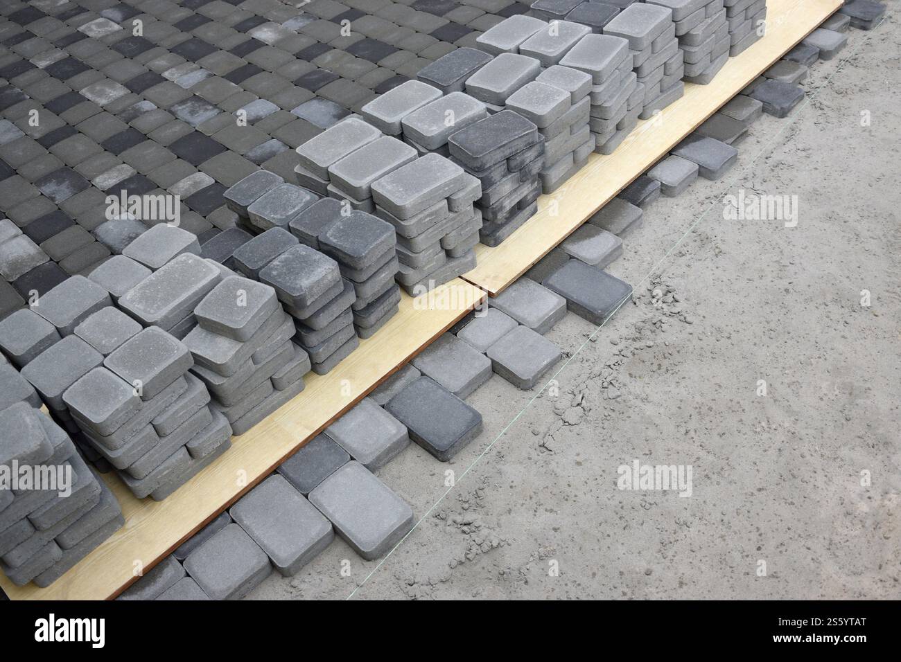 Rows of gray and dark grey walkway slab lying outdoors. Material for ...