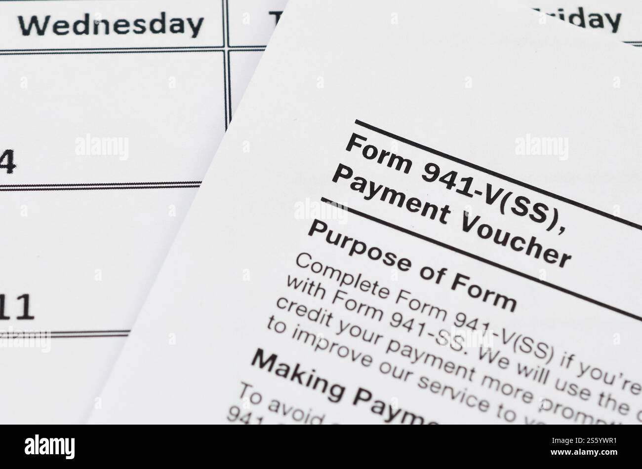 IRS Form 941-V Payment Voucher blank lies on empty calendar page. Tax ...