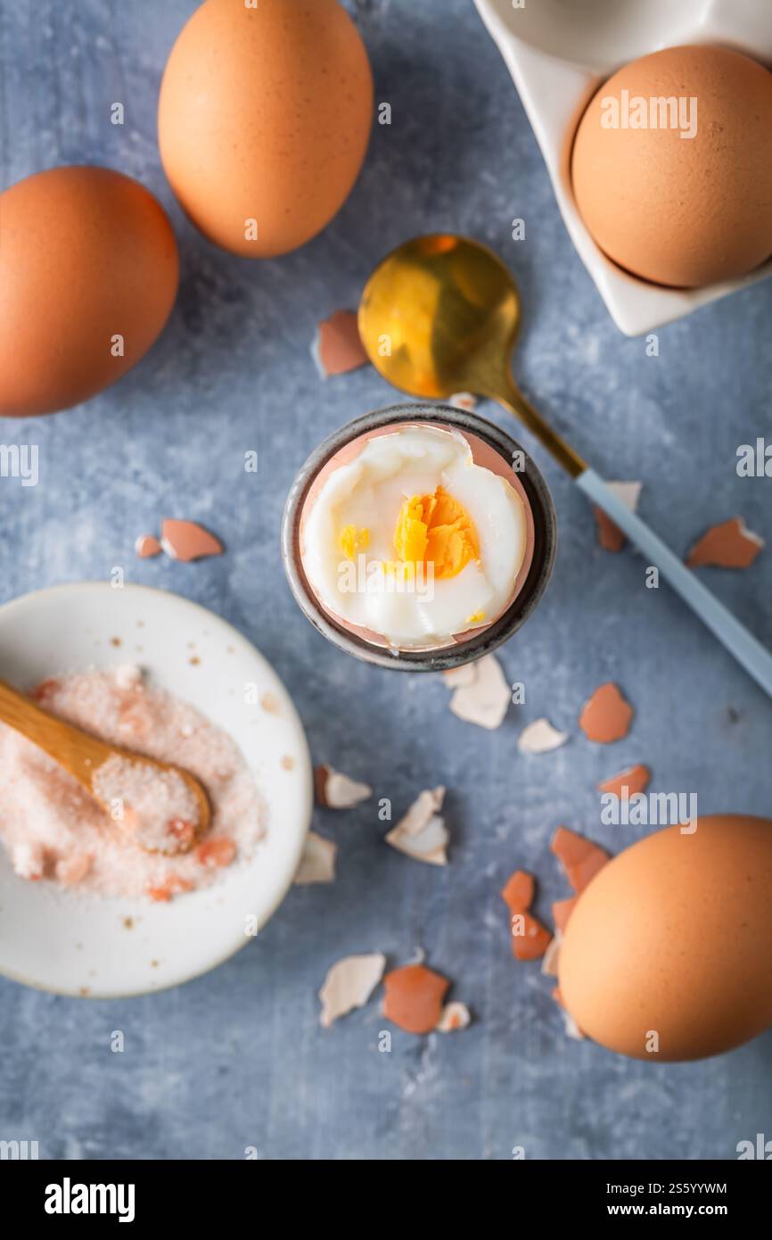 Breakfast with boiled eggs, cup of tea, milk and oat cookies Stock Photo