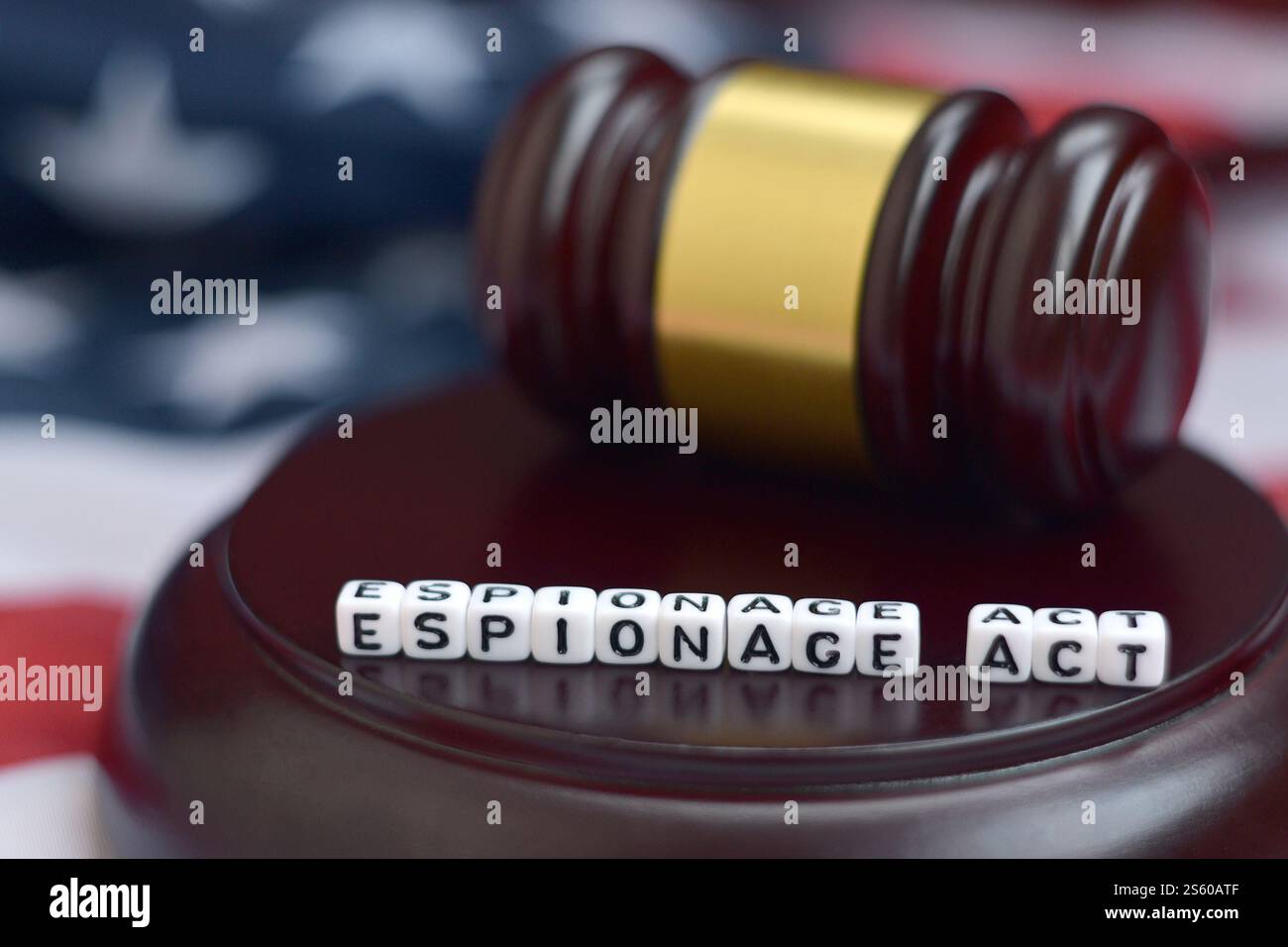 Justice mallet and Espionage act characters close up with US flag on background Stock Photo