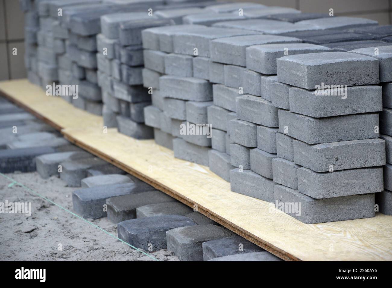 Rows of gray and dark grey walkway slab lying outdoors. Material for ...