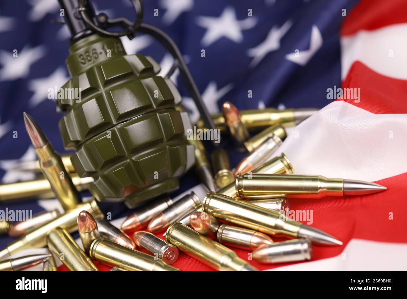 F1 frag grenade and many yellow bullets and cartridges on United States ...
