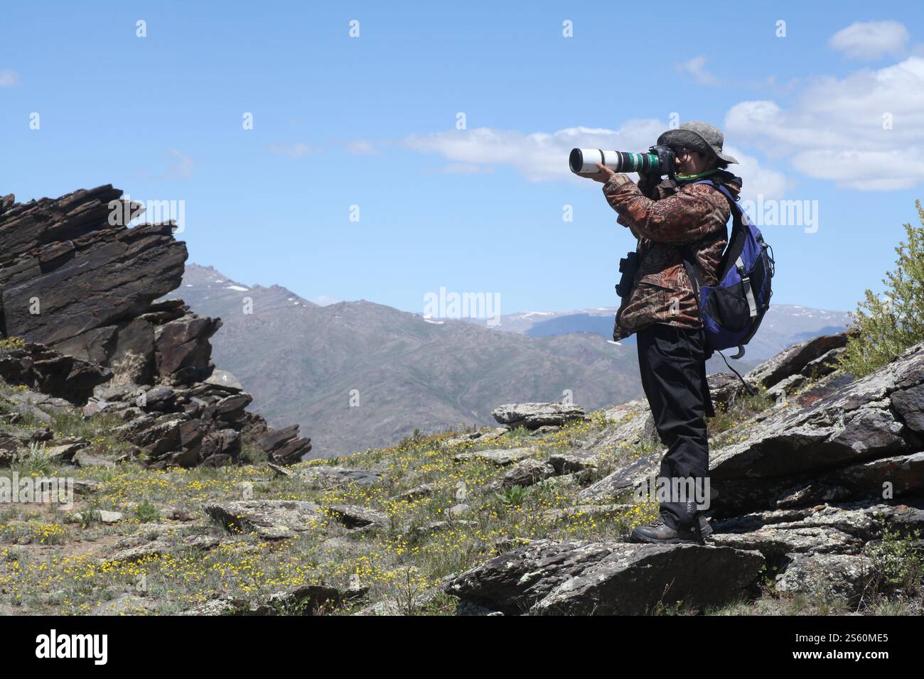 Urumqi. 15th Jan, 2025. Huang Yahui takes photos in the Tianshan Mountains in northwest China's Xinjiang Uygur Autonomous Region in 2024. TO GO WITH 'Feature: Chasing butterflies, protecting nature amid Xinjiang's wilderness' Credit: Xinhua/Alamy Live News Stock Photo