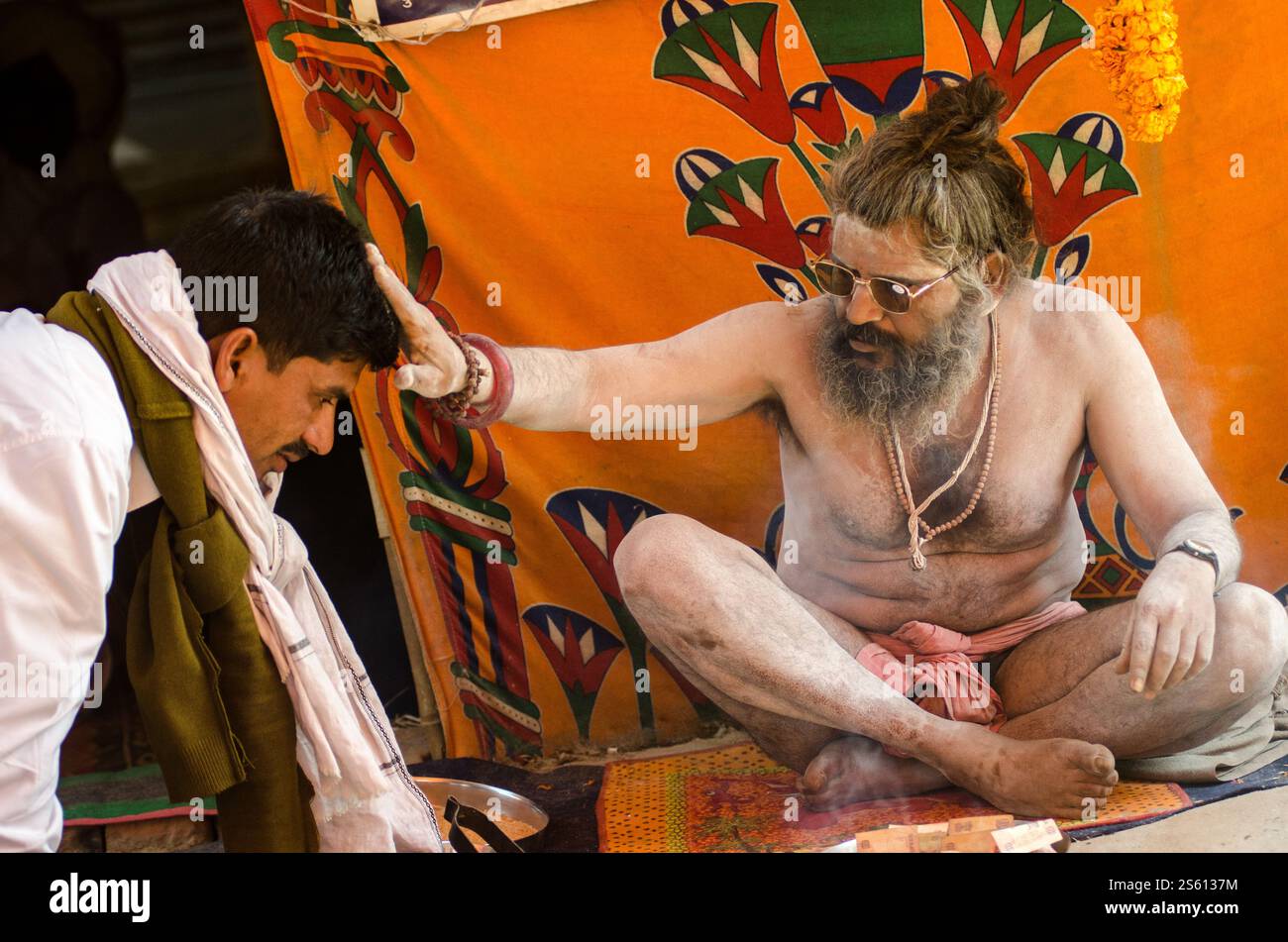 Elderly man in traditional attire at a vibrant cultural festival in ...