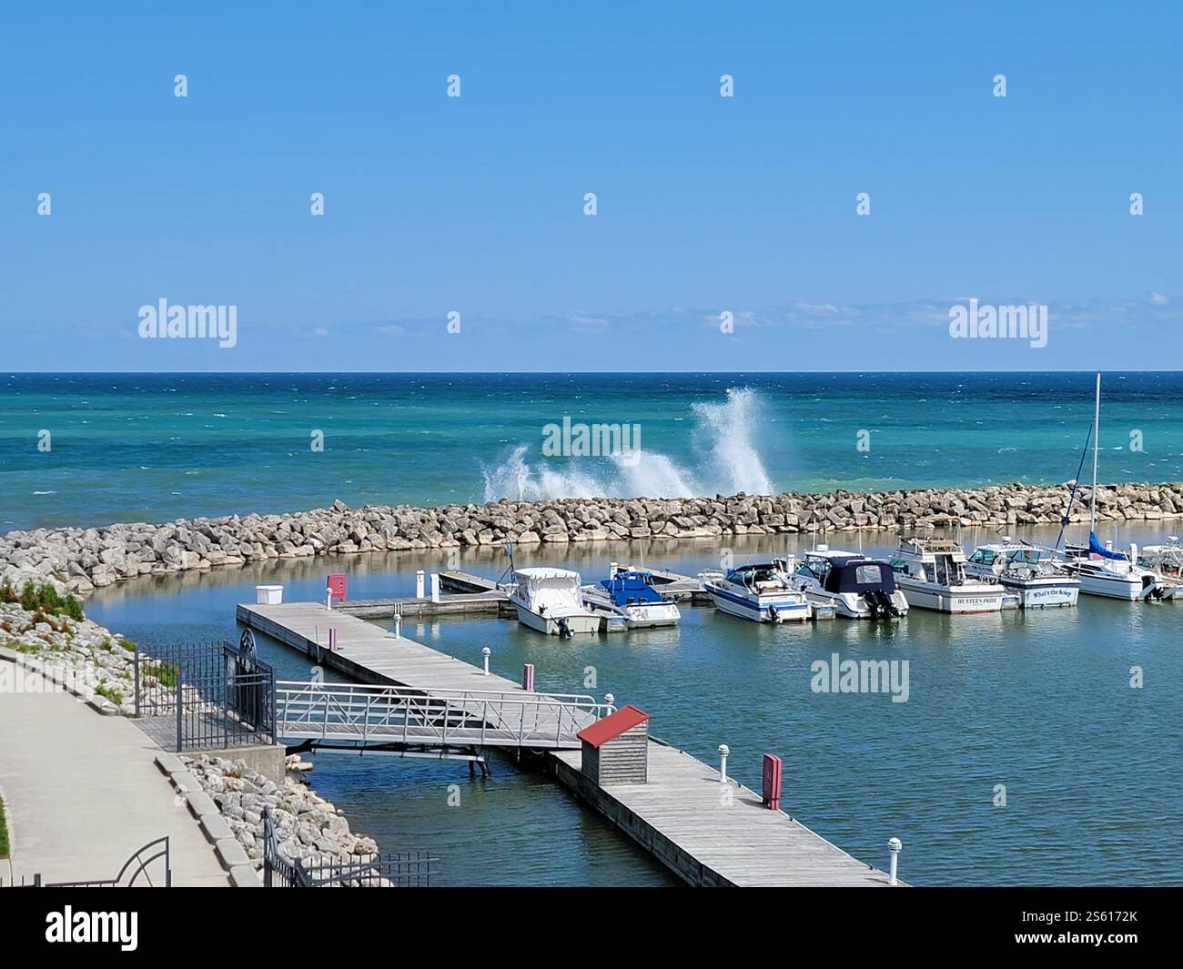 Rough weather on Lake Michigan, Sheboygan, Wisconsin. Spray is thrown up at the marina breakwater by waves on western Lake Michigan. - Smartphone Captured Stock Image