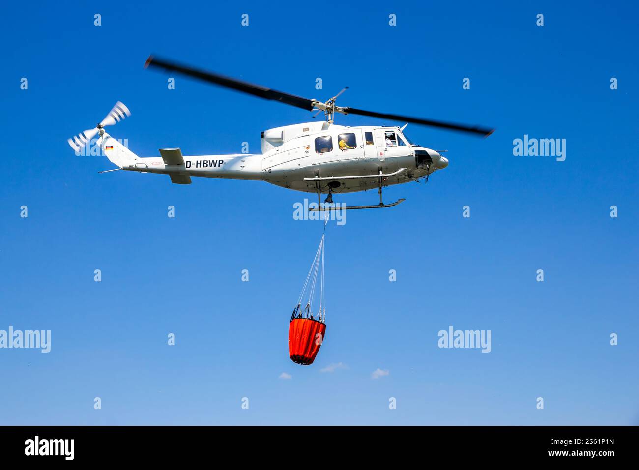 Bell 212 Helicopter with a water bucket used for aerial bush fire fighting. Ahlen, Germany - Jun 5, 2016 Stock Photo