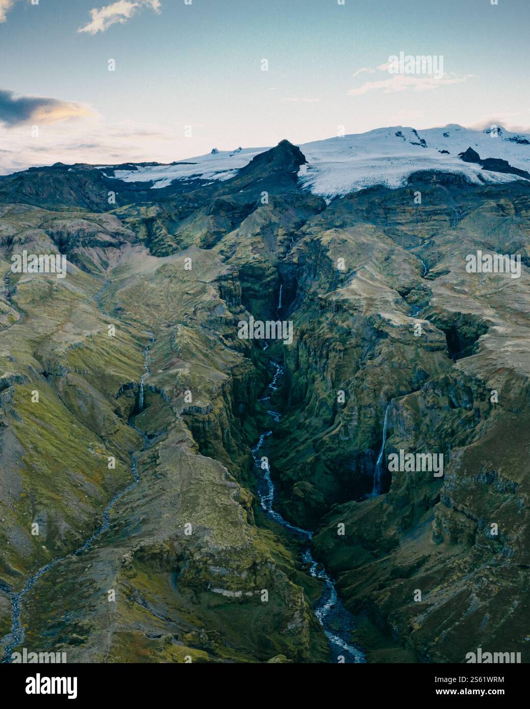 Aerial view of Mulagjufur Canyon in South Iceland, featuring dramatic cliffs, cascading waterfalls, and glacial surroundings Stock Photo