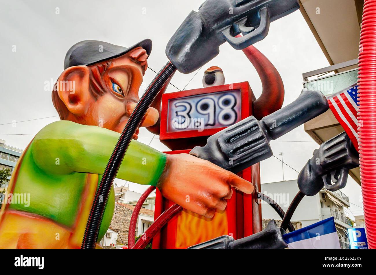 Giant Carnival Float Satirizes Gas Prices. Funny Sculpture of an Employee Holding a Pump - Gun. Great Annual Parade with Colored Statues. Stock Photo