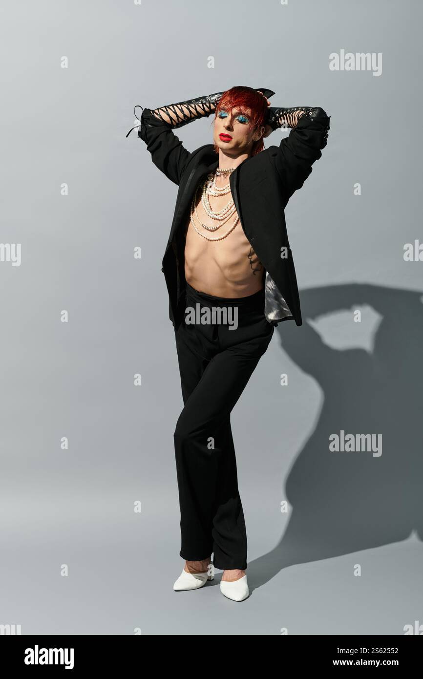 A stylish young man poses confidently, showcasing his bold fashion and ...