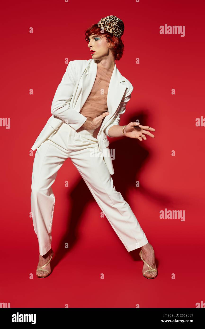 A charismatic young man in a stylish white suit and striking headpiece ...