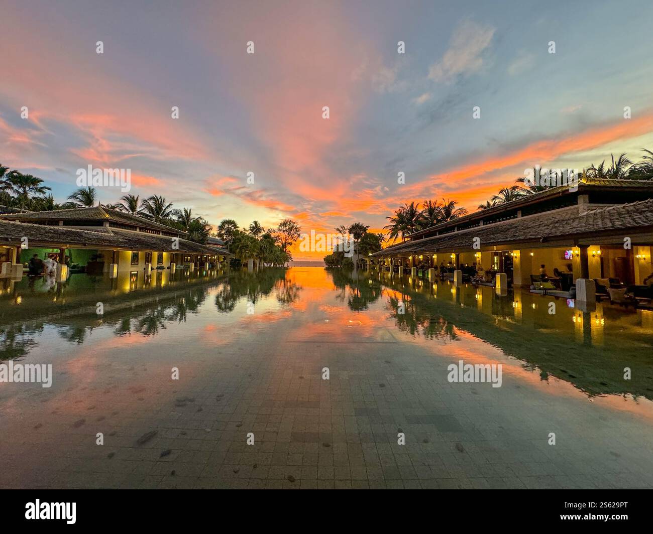 Dramatic sunset over water feature in Phuket, Thailand. Dramatic colors lighting up the sky - Smartphone Captured Stock Image