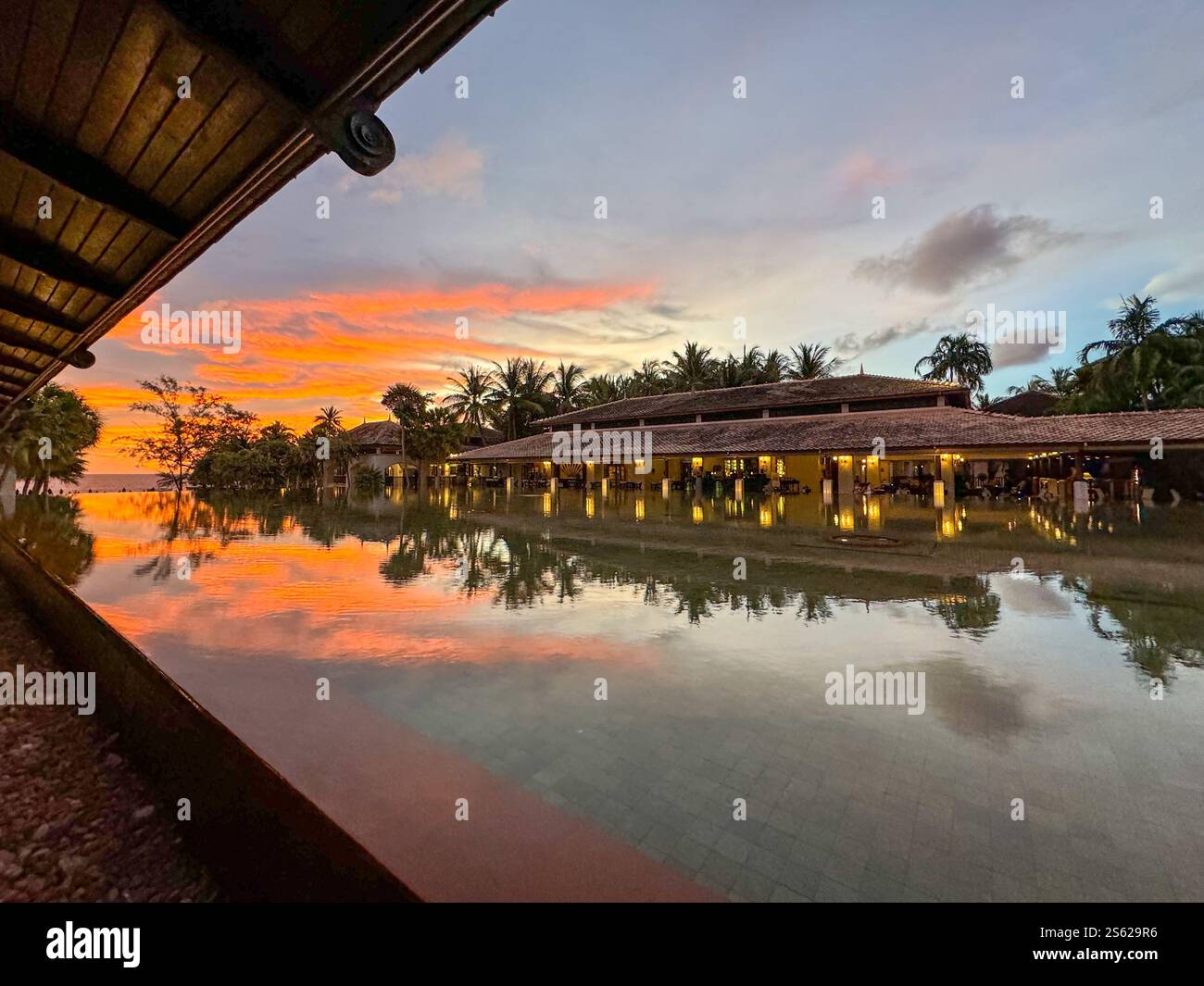 Dramatic sunset over water feature in Phuket, Thailand. Dramatic colors lighting up the sky - Smartphone Captured Stock Image