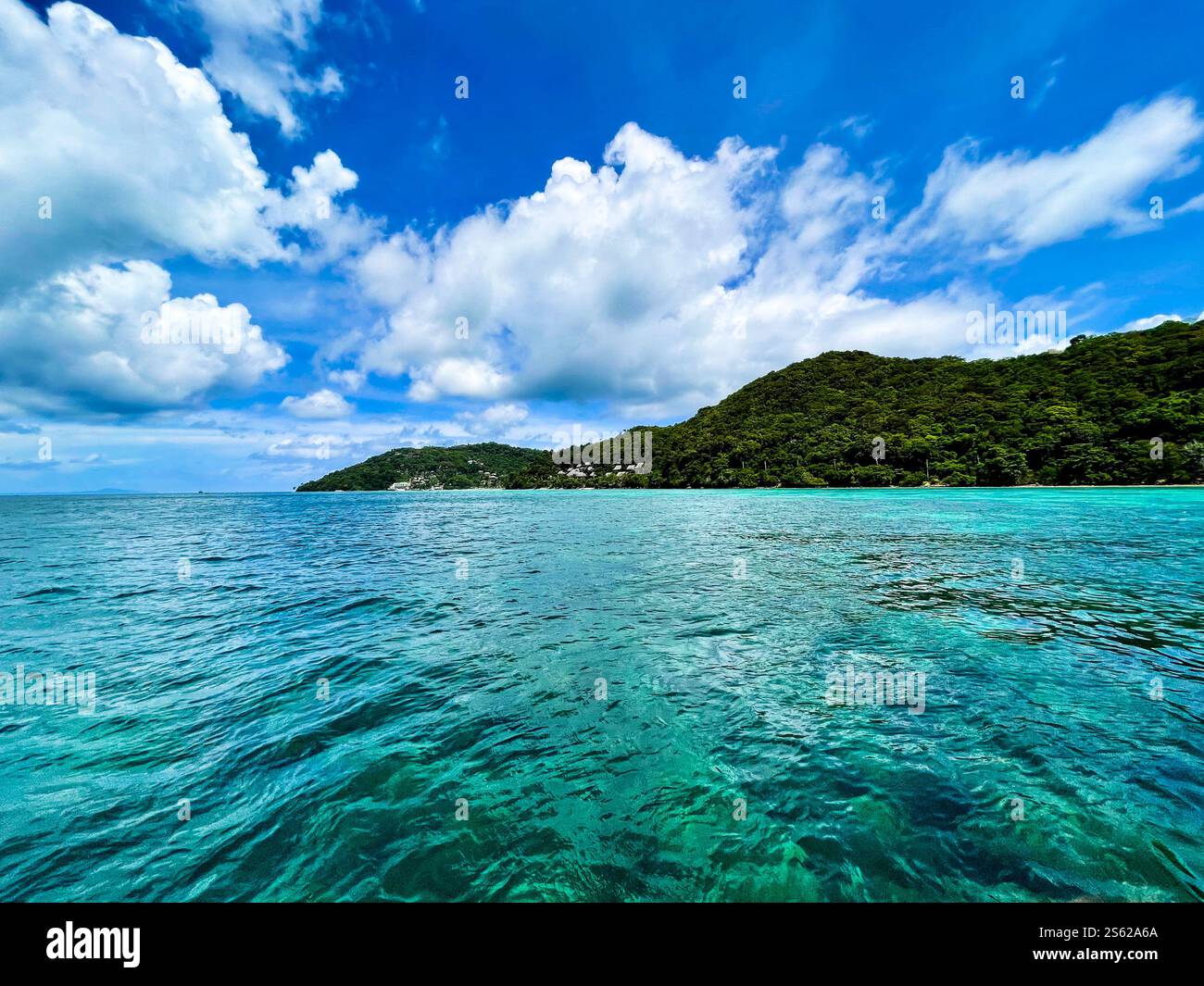 View from the sea to Thailand coast with partly blue sky and small clouds - Smartphone Captured Stock Image