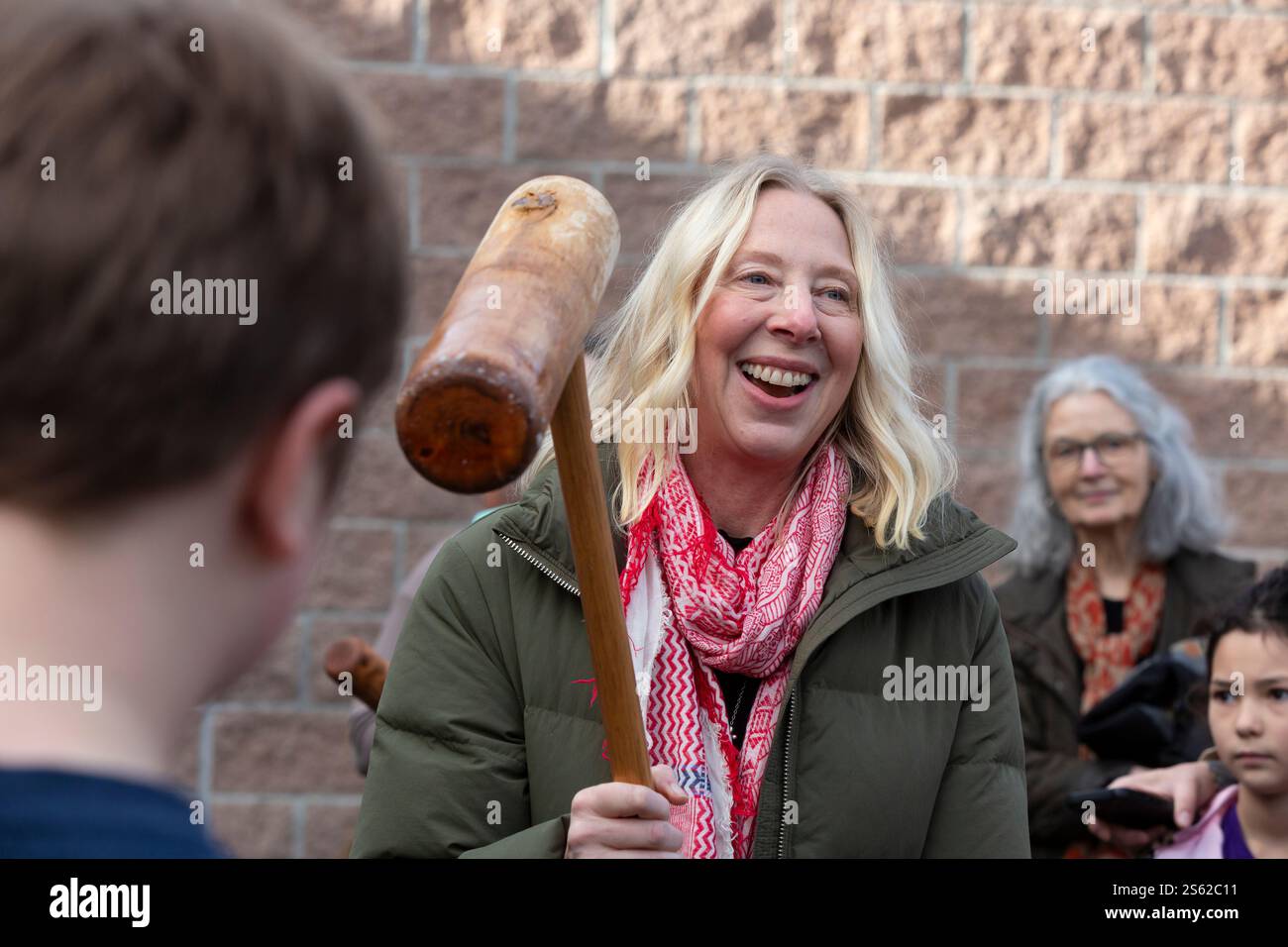 A volunteer pounds sweet rice into a paste with a kine (mallet) at the Mochi Tsuki festival on Bainbridge Island, Washington on Saturday, January 11th Stock Photo