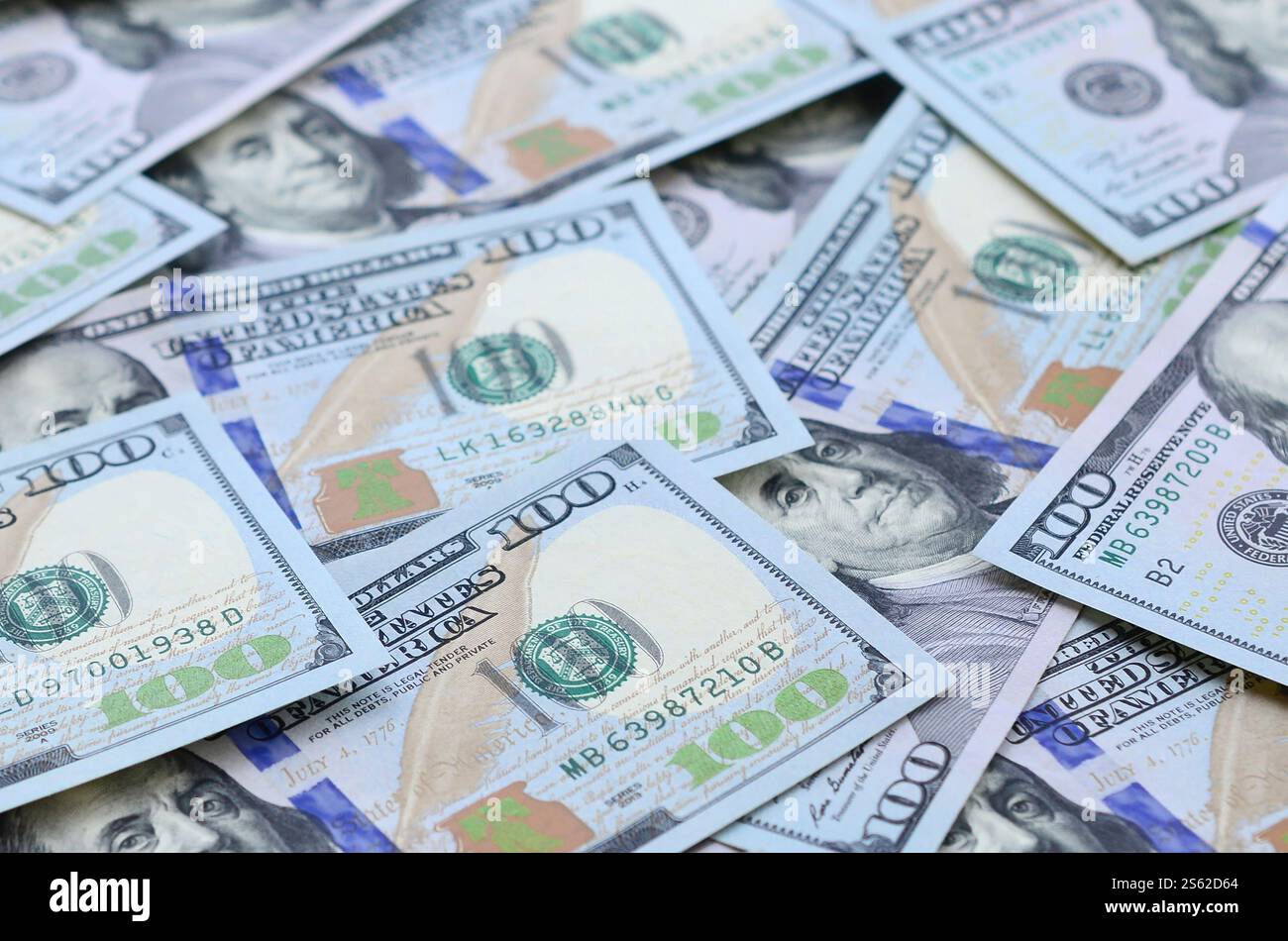 A large number of US dollar bills of a new design with a blue stripe in the middle. Top view. A large number of US dollar bills of a new design with Stock Photo