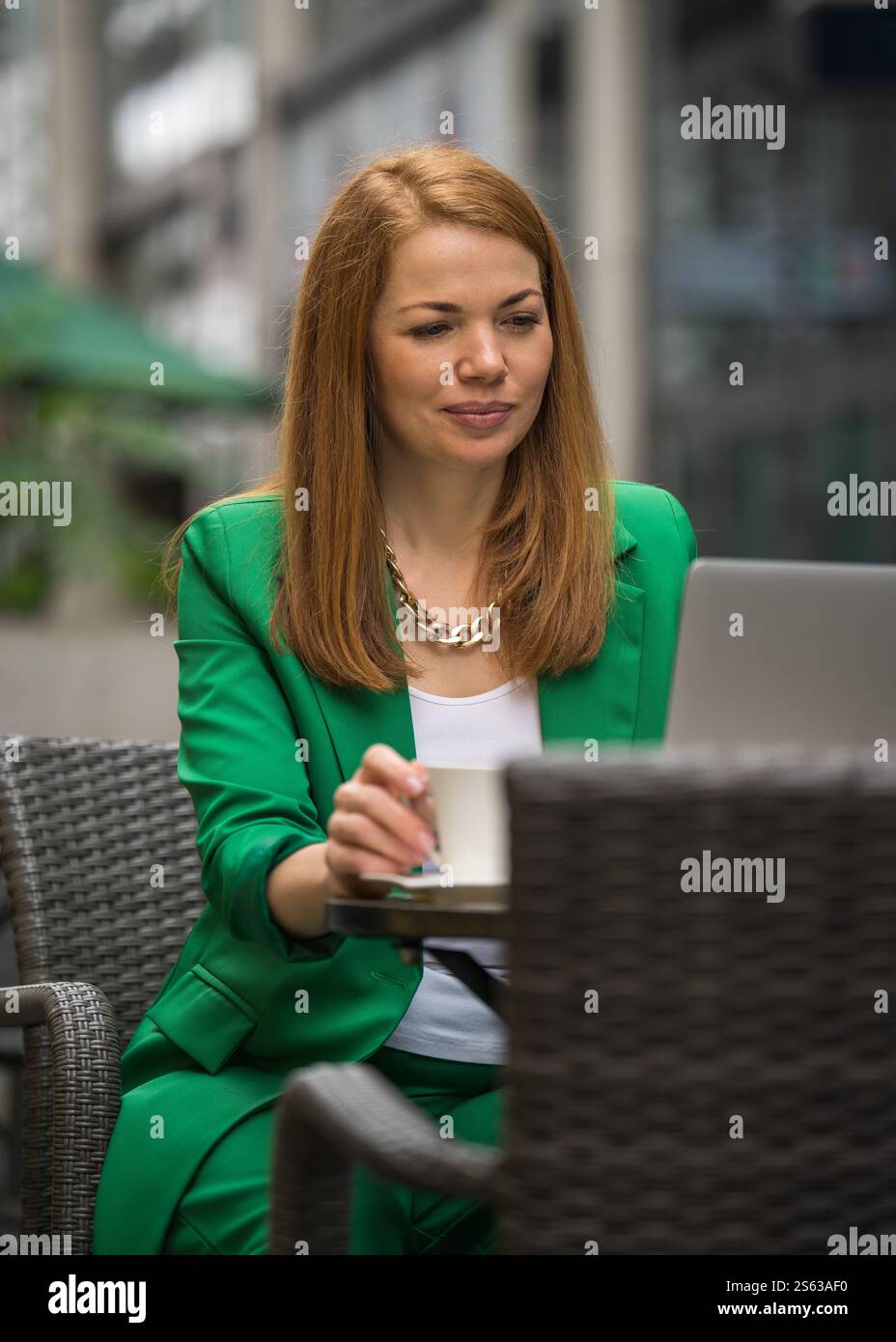 Young woman enjoys moment of pause while sitting in cozy outdoor cafe ...