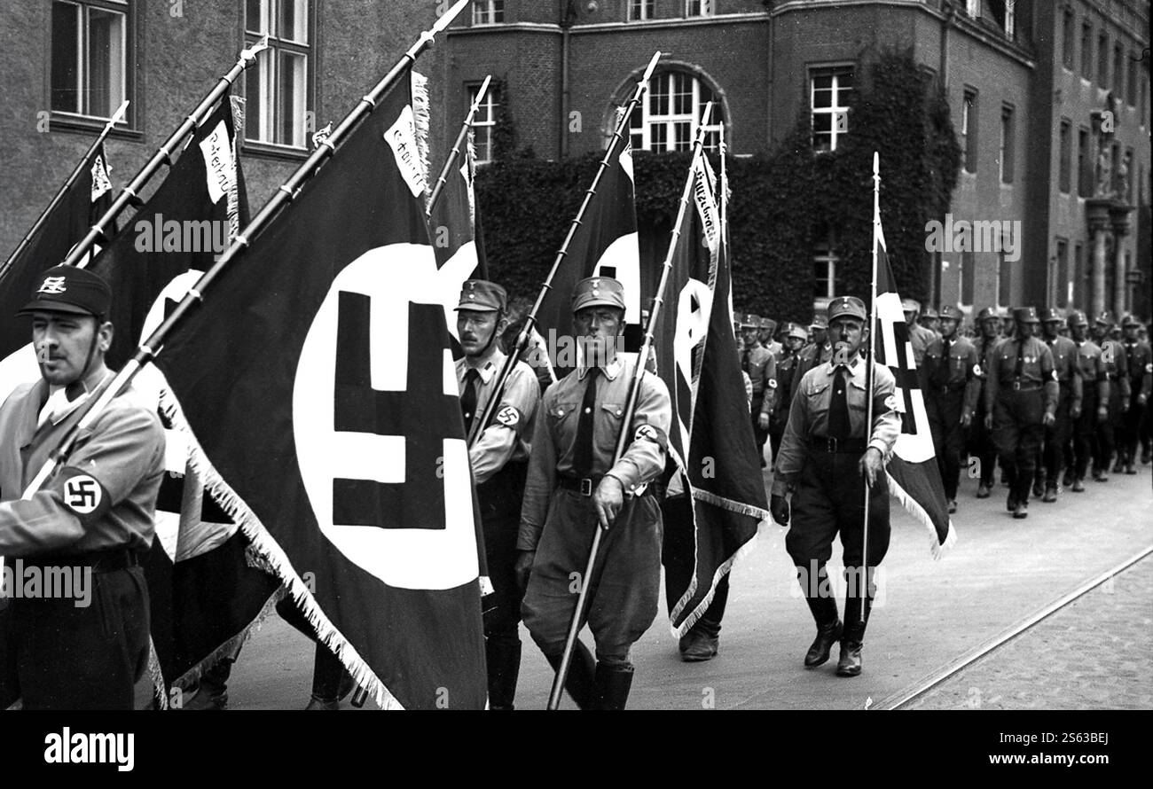 Sturmabteilung also called stormtoopers and Brownshirts carrying Swastika Flags in 1934 as they parade through Königsberg in Germany. Königsberg became Russian territory after the second world war and was renamed Kaliningrad. Stock Photo