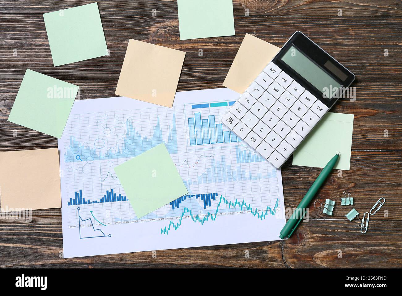 Diagrams with blank sticky notes and calculator on wooden background ...