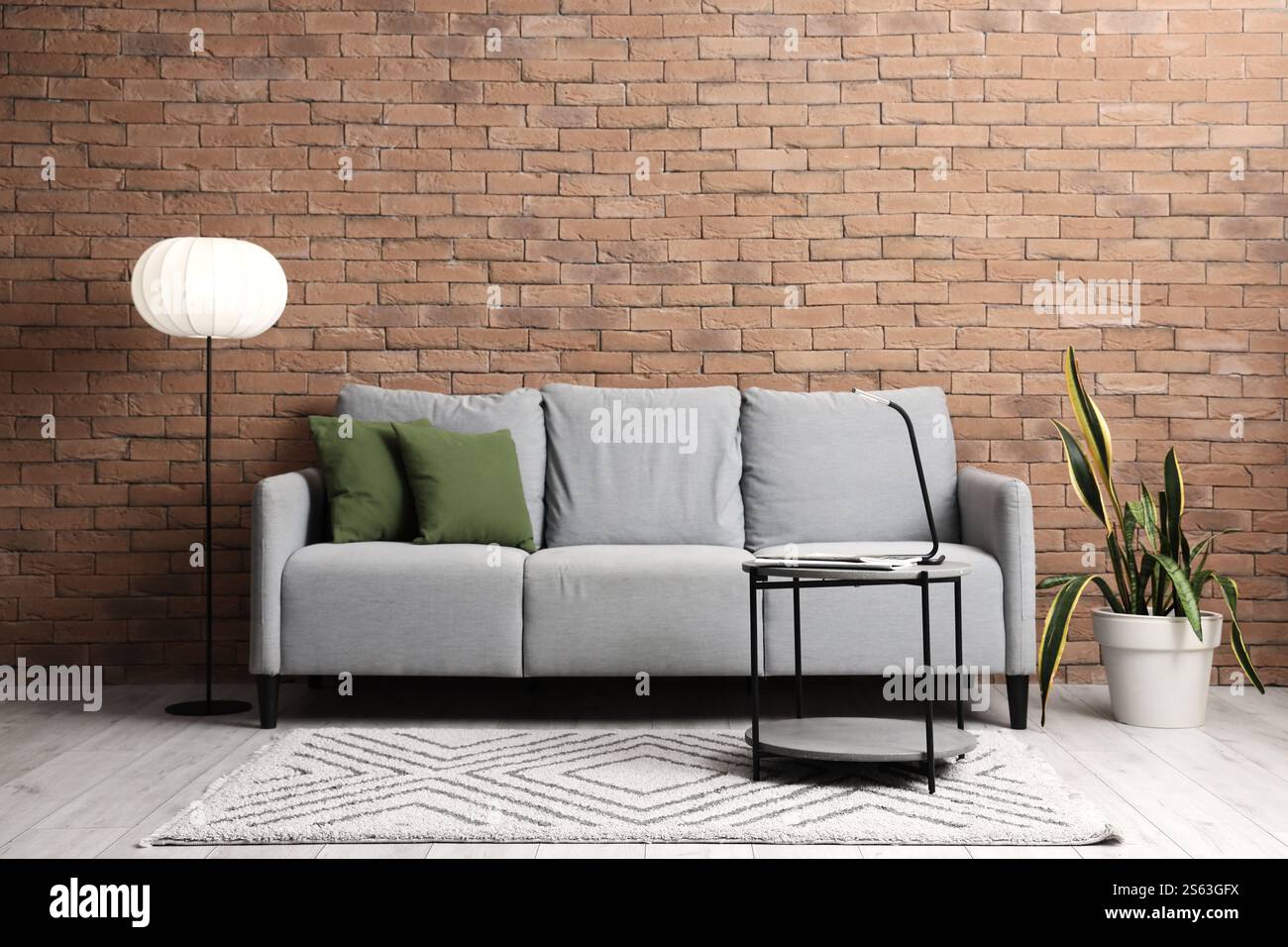 Interior of living room with grey sofa, table and glowing lamp Stock ...