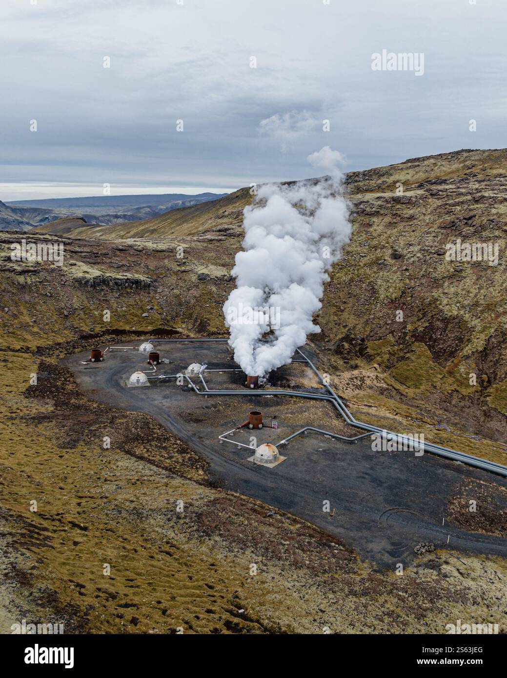 Aerial view of a geothermal power plant emitting steam on Hellisheidi ...