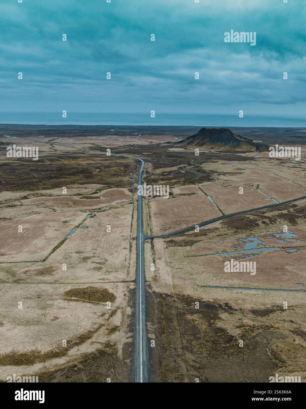 Aerial view of a long, straight road cutting through the volcanic ...