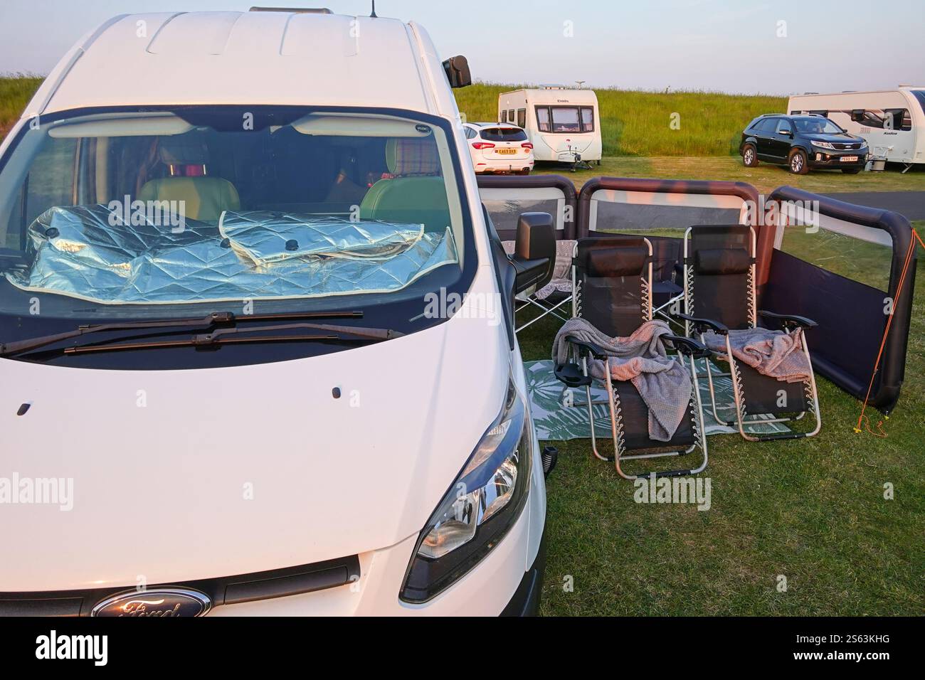 Small campervan set up on campsite Stock Photo