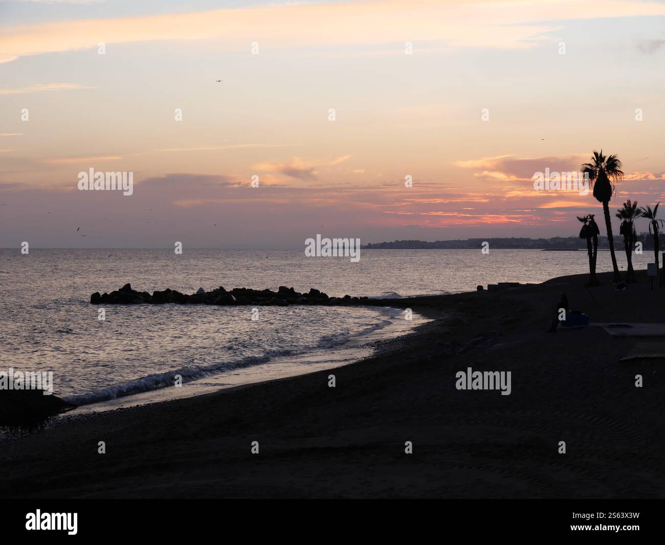 Silhouettes of Plamen in the sunset of Marbella Spain Stock Photo