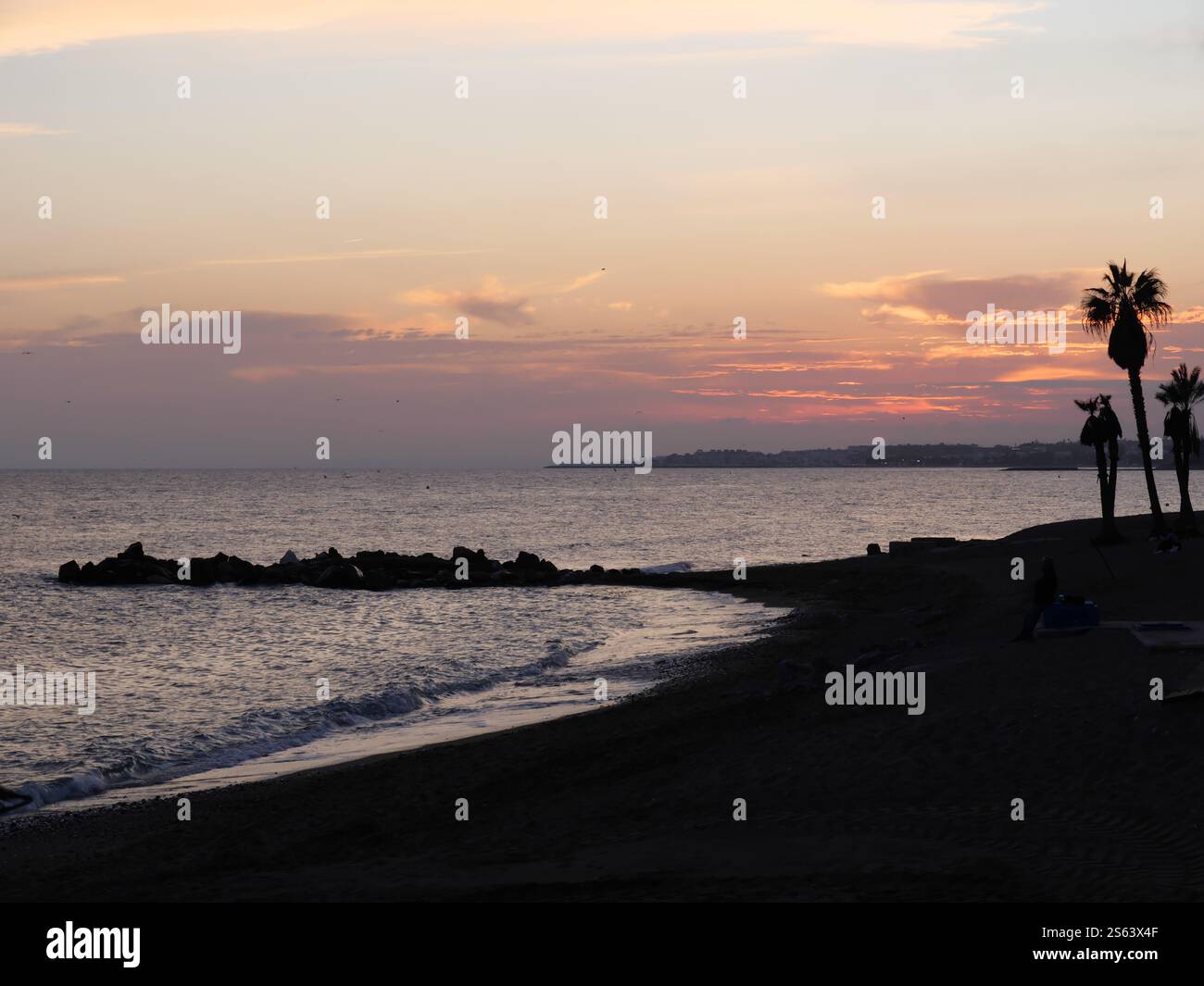 Silhouettes of Plamen in the sunset of Marbella Spain Stock Photo