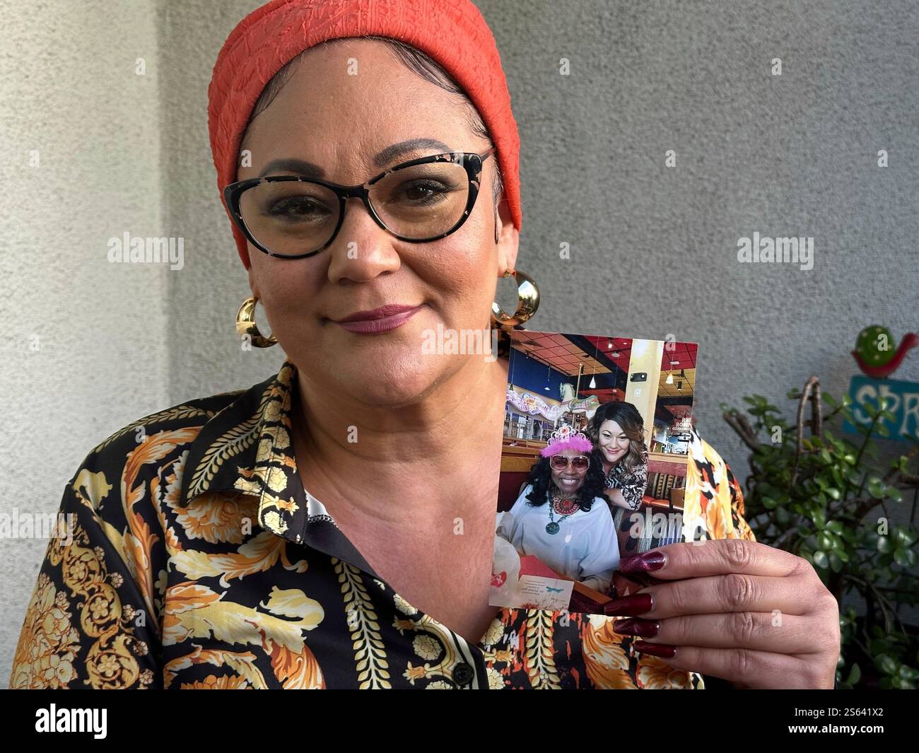 Dalyce Kelley holds up a picture of her grandmother, 95-year-old Dalyce ...