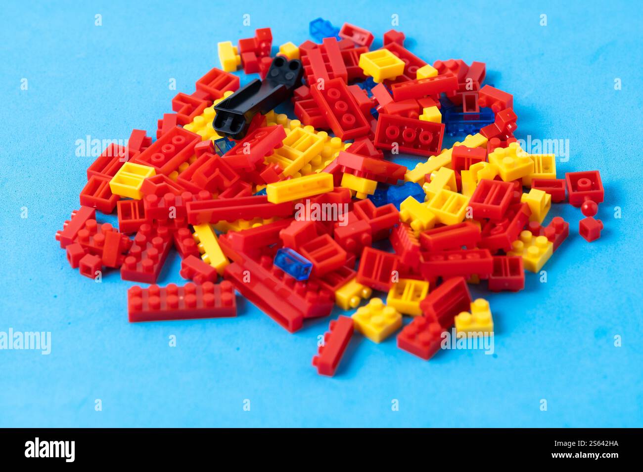 Plastic building blocks isolated on blue background. Plastic construction kit Stock Photo