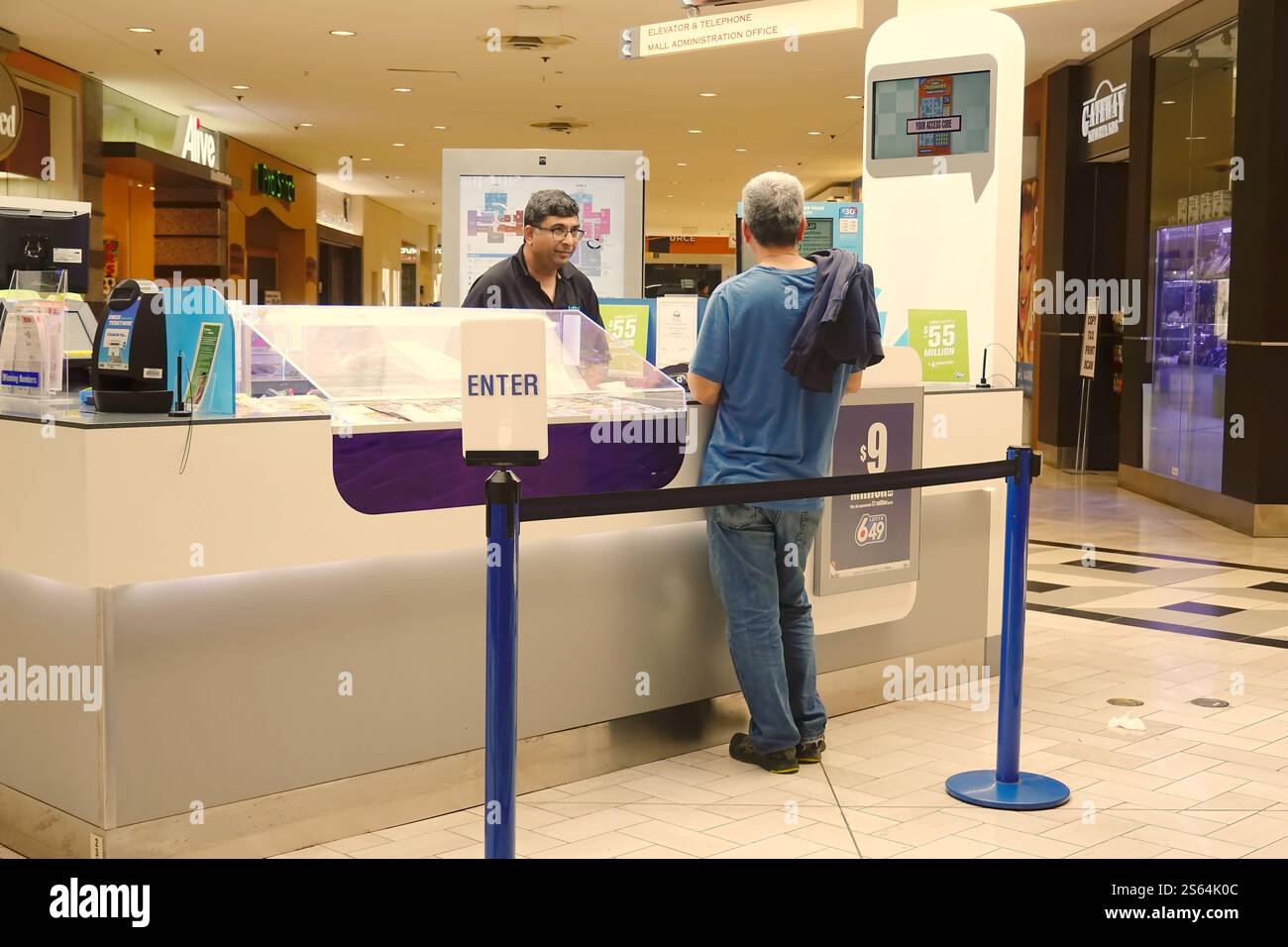 Man purchasing lottery tickets in Coquitlam Centre Mall, Coquitlam, B. C., Canada. Stock Photo