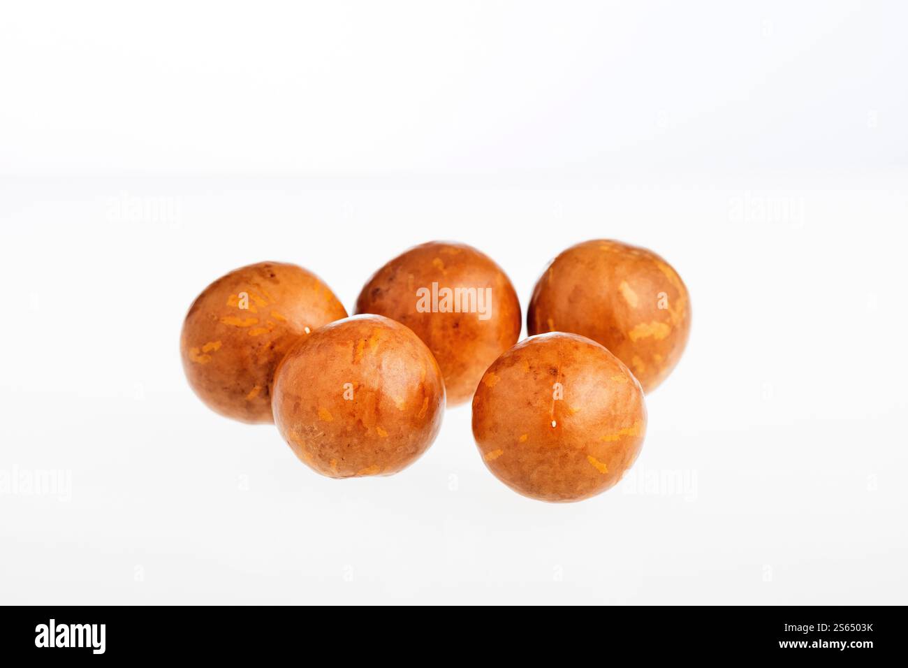 Macadamia integrifolia - Organic macadamia nuts on white background. Stock Photo