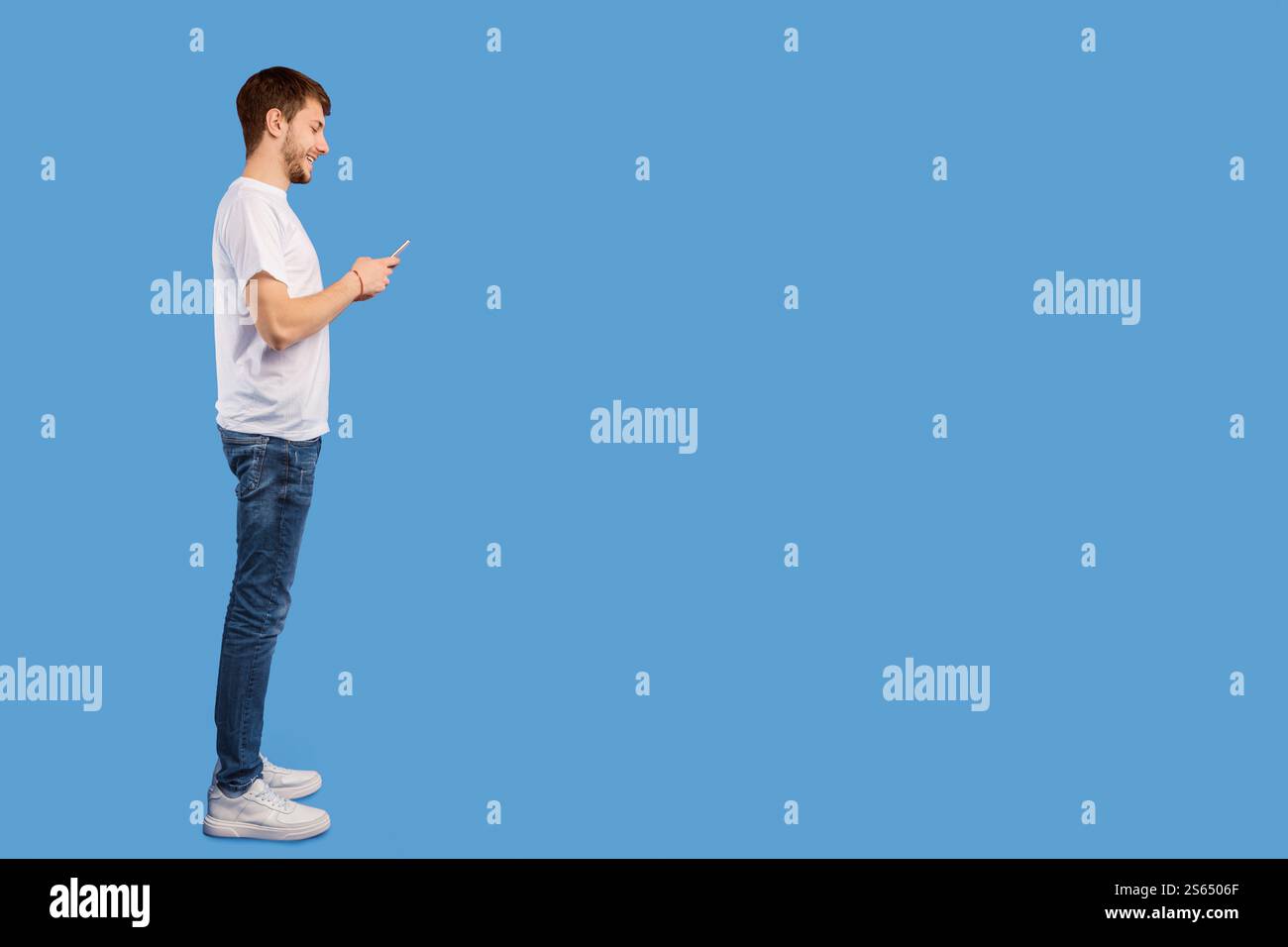 Portrait of handsome young man using mobile phone Stock Photo