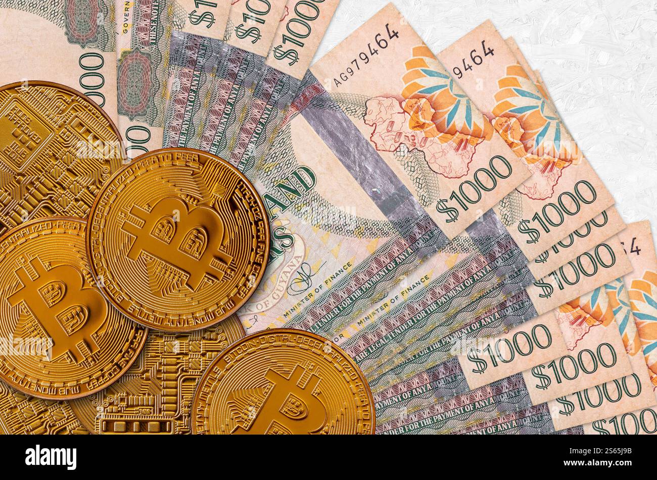 1000 Guyanese dollars bills and golden bitcoins. Cryptocurrency investment  concept. Crypto mining or trading transactions Stock Photo - Alamy
