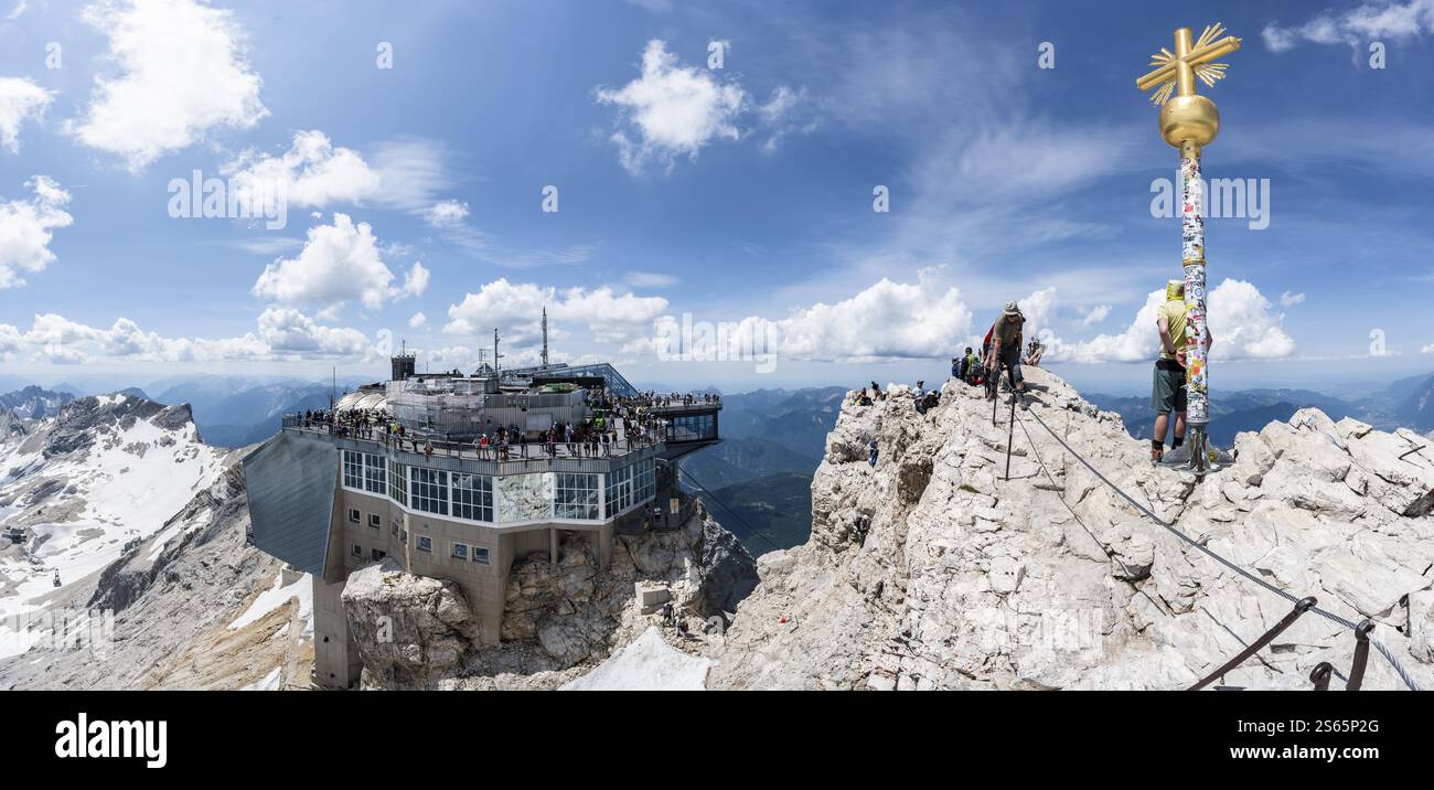 Summit of the Zugspitze with golden summit cross and modern mountain ...