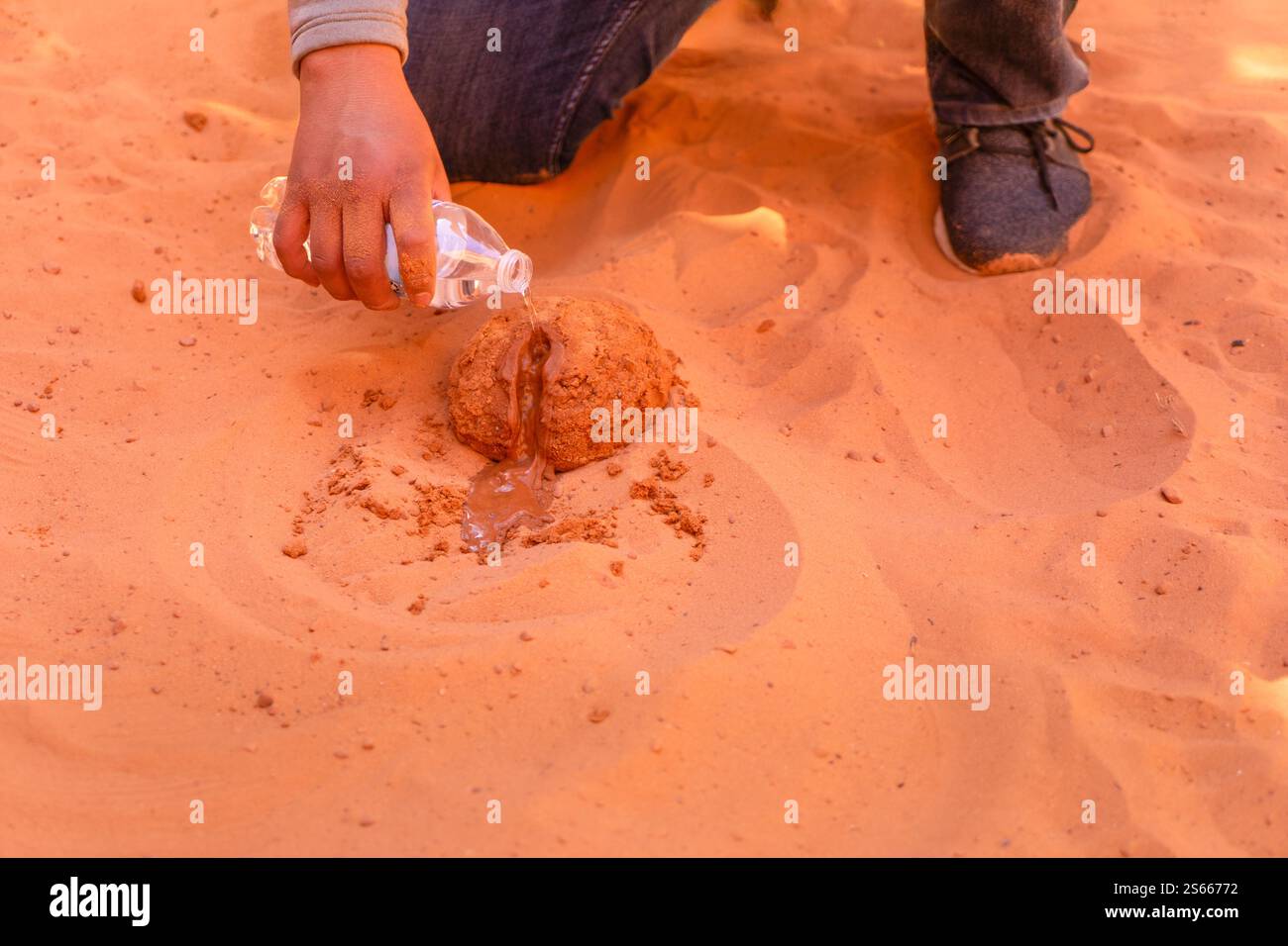 A tourist guide demonstrates how slot canyons were carved by water ...