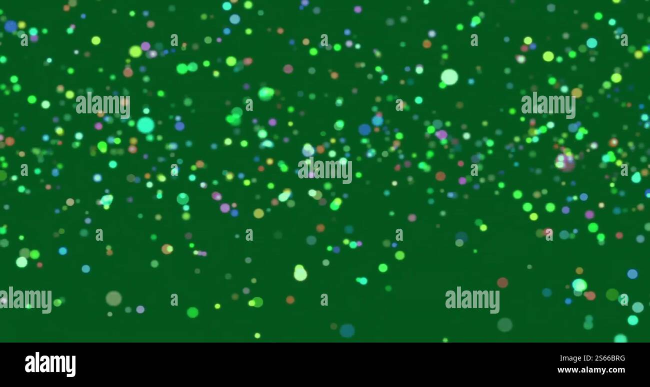 Image of glowing light spots over green background Stock Photo