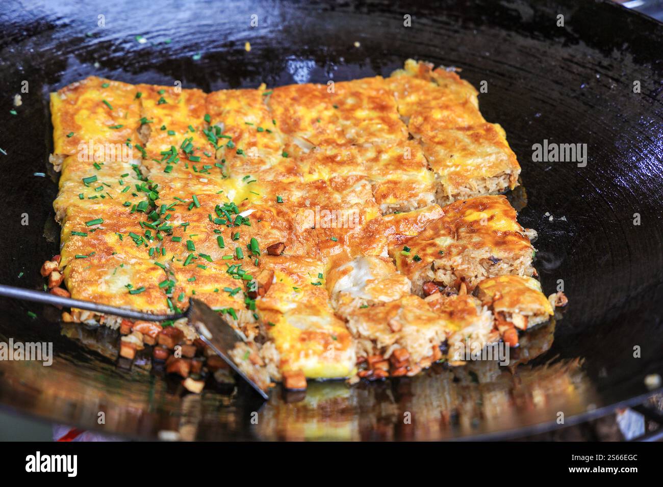 Chinese food specialty - tofu skin (Doupi) in hot wok. It is a kind of omlet made of glutinous rice with egg, mince and other ingredients. It is a fav Stock Photo