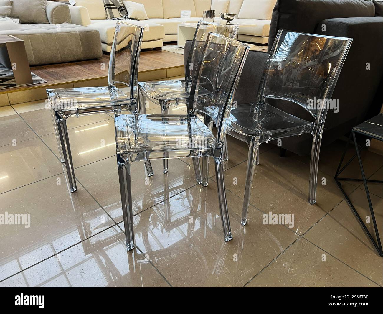A set of stylish clear chairs showcased in a contemporary furniture ...