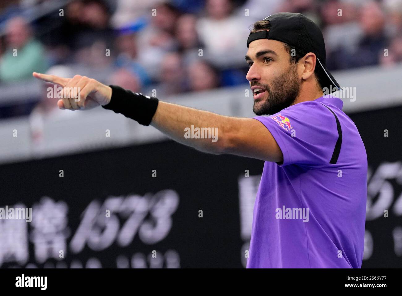 Matteo Berrettini of Italy gestures to Holger Rune of Denmark during