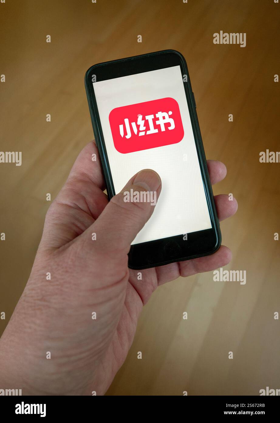 Rednote app on smartphone screen held in hand. Red Note is a Chinese ...